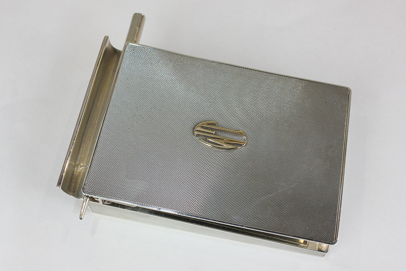 An Asprey George VI silver notebook desk stand, rectangular, with engine turned decoration, hinged
