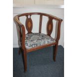 An Edwardian inlaid mahogany library armchair with pierced and oval panel supports inlaid with