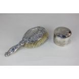 A George V Art Nouveau silver backed dressing table brush cast with flowers and scroll border, maker