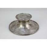 A George V silver capstan inkwell on loaded circular base, with engraved presentation inscription (