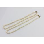 A single row cultured pearl necklace on a 9ct gold and gem set clasp, and another with a pearl set