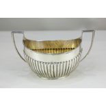 A Victorian silver two-handled sugar bowl, oval shape with demi-fluting, maker Barnards, London