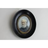 A 19th century oval miniature portrait of an old man, with white hair and beard, on ivory, signed M.