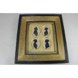 A 19th century framed family group of oval silhouette profile portraits, comprising a gentleman