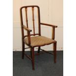 An Art Nouveau inlaid mahogany carver dining chair, with two shaped back splats decorated with plant