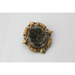 A large gold Victorian Mourning brooch