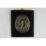 A 19th century oval miniature portrait of a lady, with long brown hair, on card, 9.5cm by 7.5cm