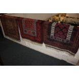 An Afghan Baluch prayer rug, geometric design in crimson and orange, 123cm by 79cm, and two