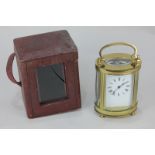 A gilt brass and bevelled glass cased carriage clock of oval form, with Roman numerals, 15cm high,