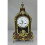 A 19th century French boulle mantel clock, with brass inlay and gilt metal mounts, the circular dial