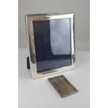 A modern silver framed rectangular photograph frame with plain border, maker Mappin & Webb, glass