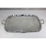 A George V silver two-handled serving tray, rectangular shape with scalloped border, maker Fenton