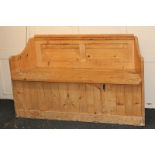 A pine settle with panelled back and slatted seat, 135cm