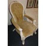 A white painted balloon back armchair with button upholstered back, open padded arms, on floral