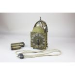 A small brass hook and spurs lantern clock with alarm, the 4 inch chapter ring with mask pierced