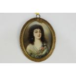 An oval miniature portrait of a young lady, in white dress with floral corsage, on ivory, in