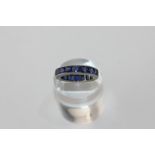 A sapphire full hoop eternity ring channel set with square cut stones