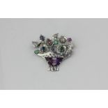 A mixed colour gem set Giardinetto brooch in unmarked white metal