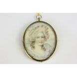 A late 19th century oval miniature portrait of a lady, in white frilled collar, on ivory, in