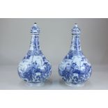 A pair of Chinese blue and white porcelain bottle vases and covers decorated with warriors and other