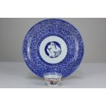 A Chinese porcelain tea bowl depicting seated figures, together with a Chinese blue and white dish