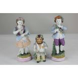 A pair of bisque porcelain figures of a boy and girl, 20cm high, (a/f), together with a bisque