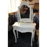 A modern white painted dressing table with foliate carved decoration and adjustable mirror, on