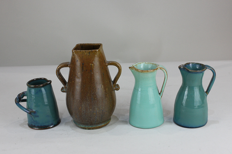 A near pair of Dicker Ware pottery jugs in shades of blue (one a/f), together with a Dicker Ware