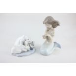 A Nao porcelain model of a mermaid holding a pearl, 21cm, and a Lladro group of three polar bears,