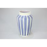 A Poole Pottery baluster vase decorated in blue, black and yellow stripes on white ground, 22.5cm