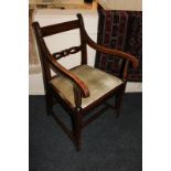 A carver dining chair with pierced horizontal bar back, curved arms on rope twist supports and