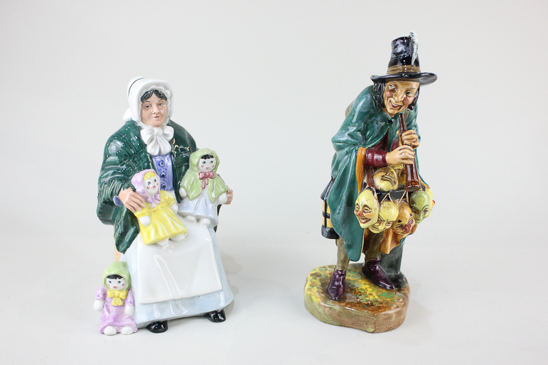 Two Royal Doulton porcelain figures, The Mask Seller HN2103, 22.5cm, and The Rag Doll Seller HN2944,