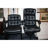 A black leather reclining office chair on swivel base with castors, and another black leather office