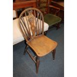 A Windsor chair with wheel and stick back and elm seat, on turned legs