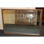 A gilt framed rectangular wall mirror with scrolling foliate decoration, mirror plate 50cm by 74.