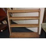 A pine bookcase with four open shelves, on plinth base, 97cm