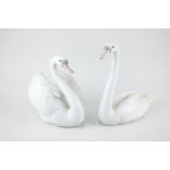 Two Lladro porcelain models of swans, 21cm and 17cm