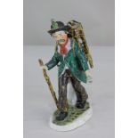 A German Pressig (Bavarian) porcelain figure of a hawker with bell and stick, 21cm high
