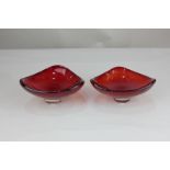 A pair of Whitefriars ruby red glass bowls of trigonal form, designed by Geoffrey Baxter (pattern
