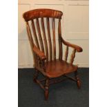A farmhouse kitchen armchair with slatted back, turned supports and elm seat