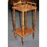 A mahogany two-tier occasional side table with three-quarter gallery back, shaped rectangular top