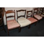 A pair of early 19th century mahogany dining chairs with carved bar backs, drop-in seats, on