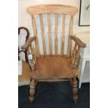 A farmhouse kitchen armchair with curved slatted back, with scroll arms, on turned supports and