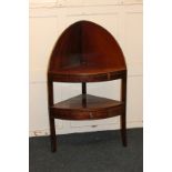A George III mahogany two-tier corner washstand with later top, central drawer (rear leg missing),