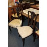 Two mahogany framed dining chairs with scroll carved back and central pierced urn splat back,