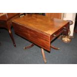A 19th century mahogany Pembroke table with two drop flaps, drawer and opposing dummy drawer, on