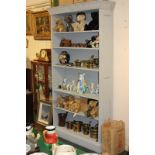 A grey painted wood bookcase with foliate and acorn decorated cornice and five adjustable shelves,