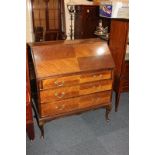 An Edwardian Maple & Co mahogany bureau with fall front enclosing fitted interior, three long