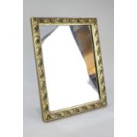 A gilt framed rectangular dressing table mirror with scrolling foliate decoration, mirror plate 29cm