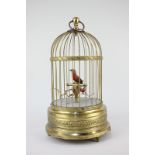 A mechanical singing bird in a gilt cage, cage 29.5cm high